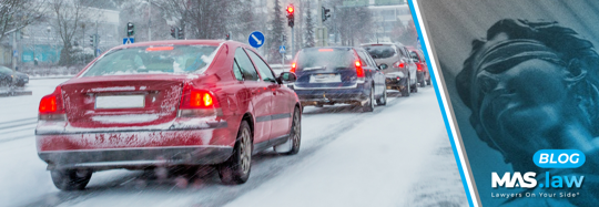 Line of cars driving in the snow | MAS Law