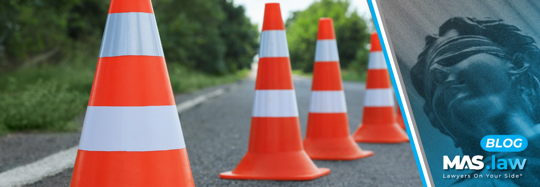 Traffic cones lined up on a road | MAS Law