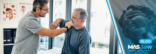 A physical therapist working on a man's shoulder | MAS Law
