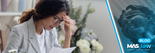A woman reading her injury claim denial | MAS Law