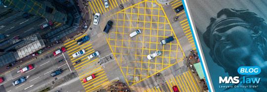 Aerial View of Cars Driving Through Intersection | MAS Law