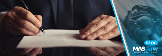 Attorney filling out paperwork | MAS Law