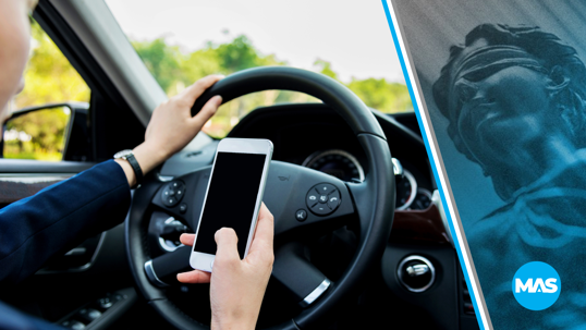 Image of distracted driver using cell phone.