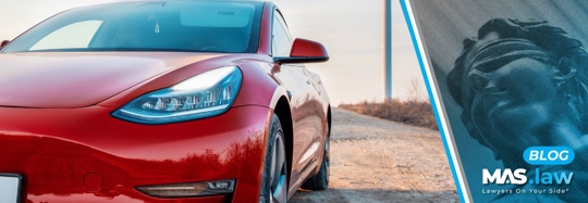 Tesla parked on a dirt road | MAS Law
