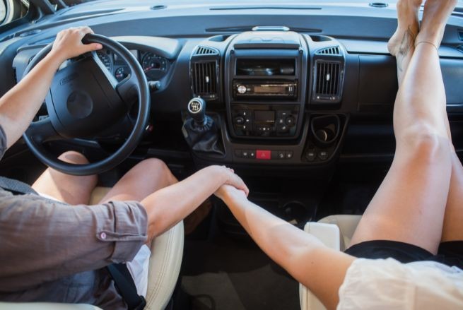 Couple driving and holding hands | MAS Law