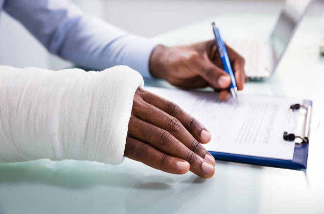 Injured person filling out paperwork | MAS Law