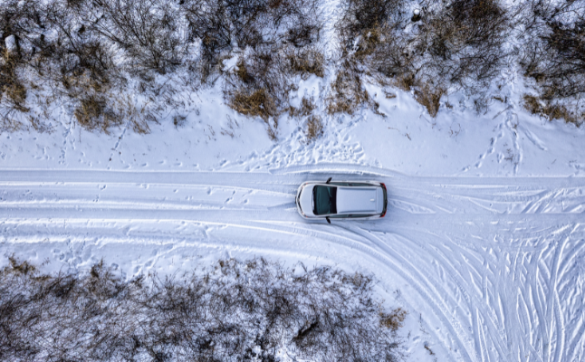 White car driving in the snow | MAS Law
