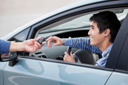 Someone handing car keys to a teen driver | MAS Law