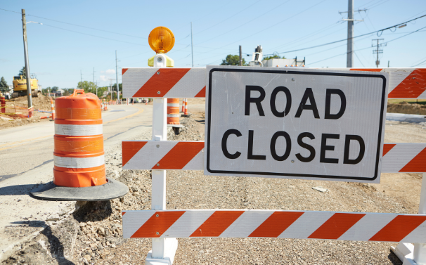 Road closed sign blocking a street | MAS Law