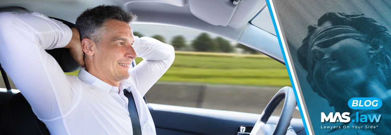 Man relaxing in a self-driving car | MAS Law